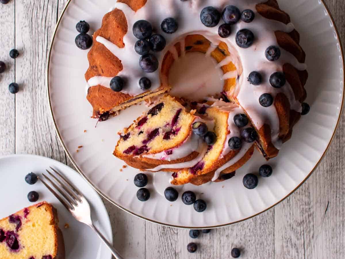Bundt cake with white glaze; slices cut and showing the inside viewed from above.