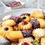 Italian Butter Cookies with various toppings on a white plate.