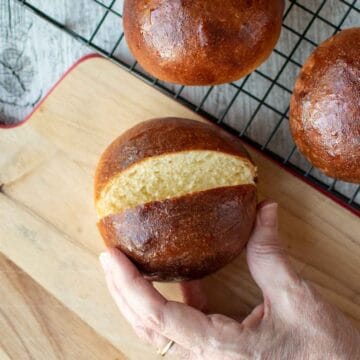 Round brown bun cut in half but not all the way through.