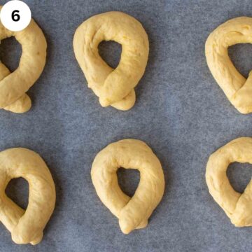Dough in the shape of a doughnut on a baking sheet.