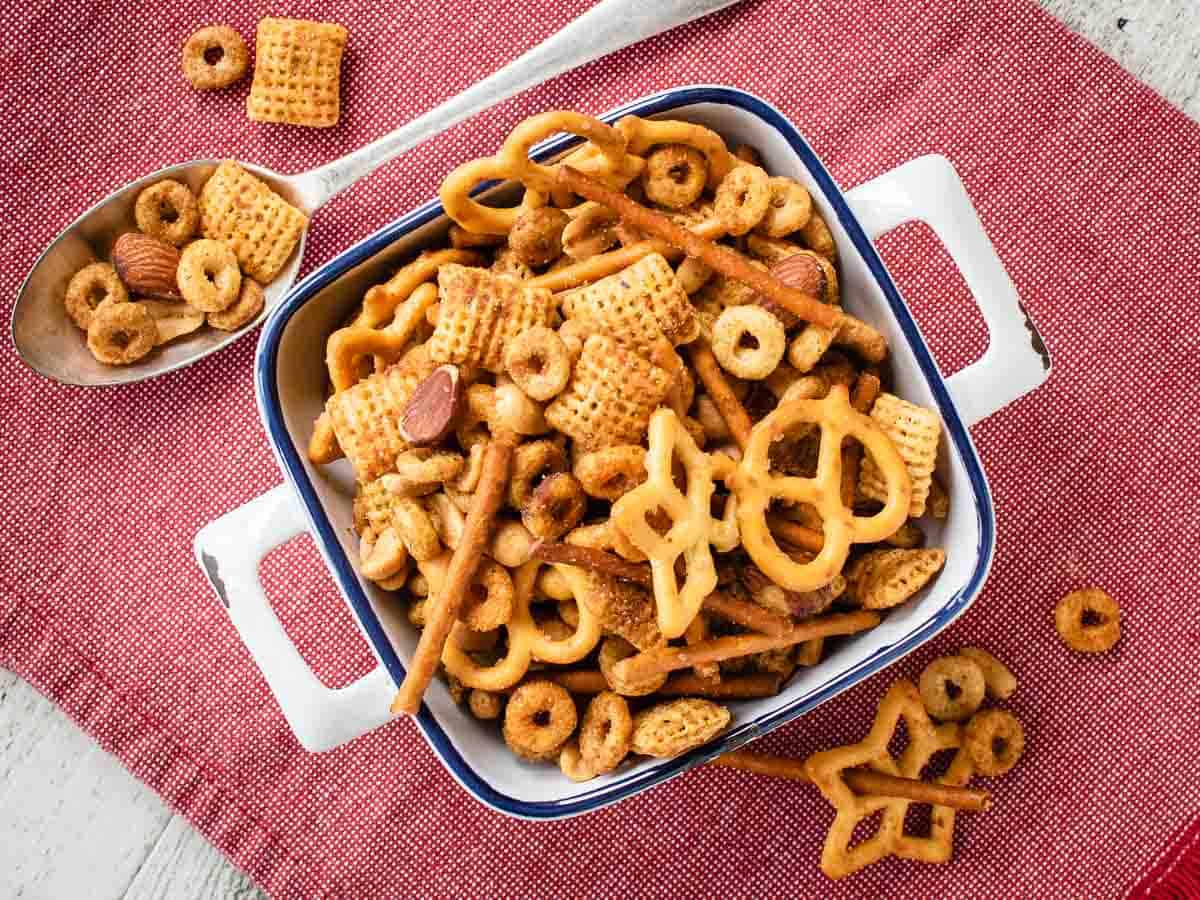 Overhead view of cereal and nut snack mix in a square dish.