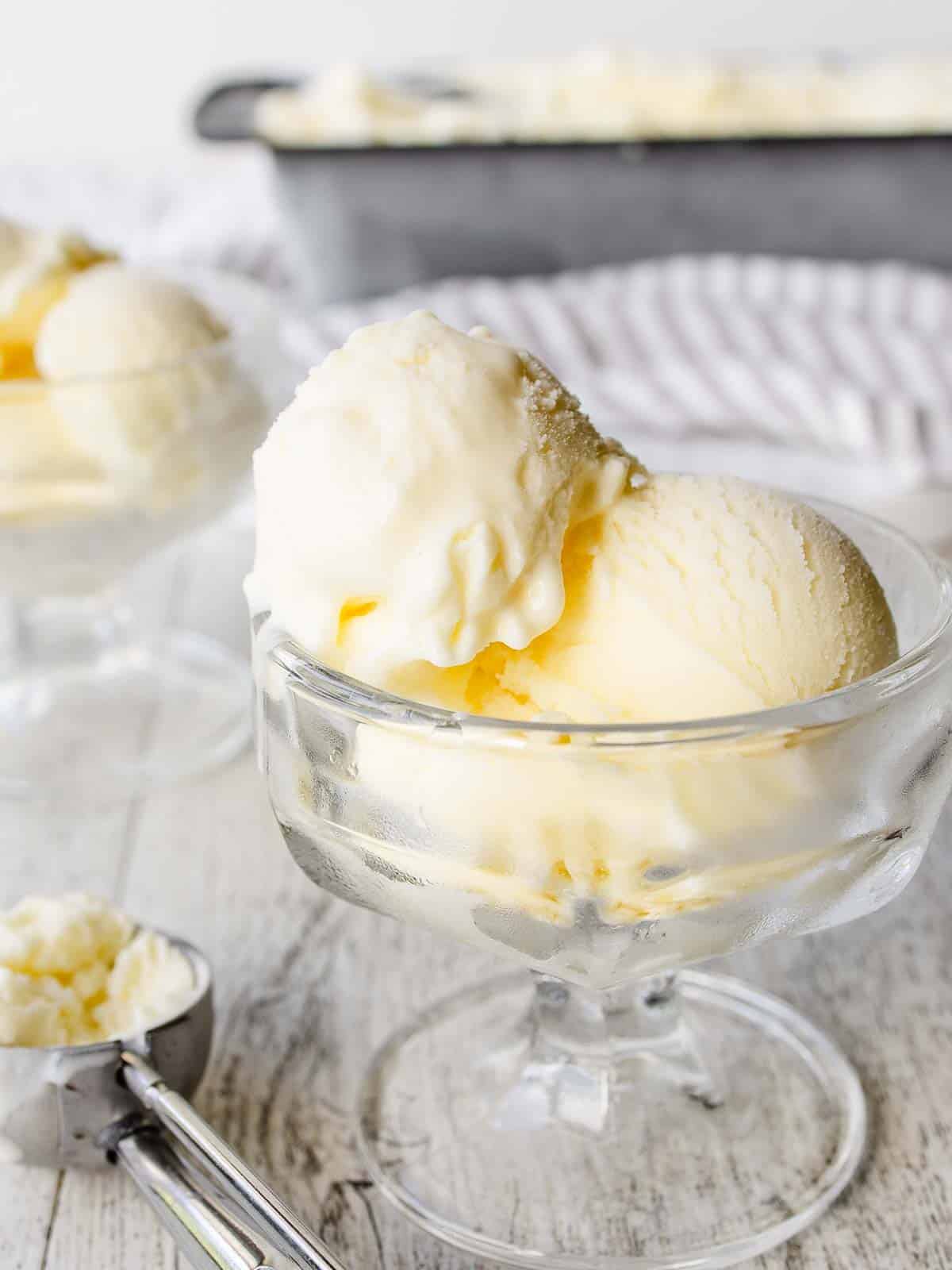 Scoops of Mascarpone Ice Cream in a glass dessert bowl.