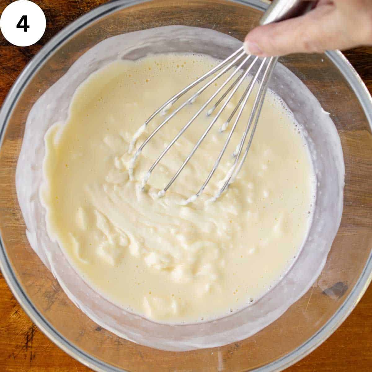 Whisking thick, creamy liquid.