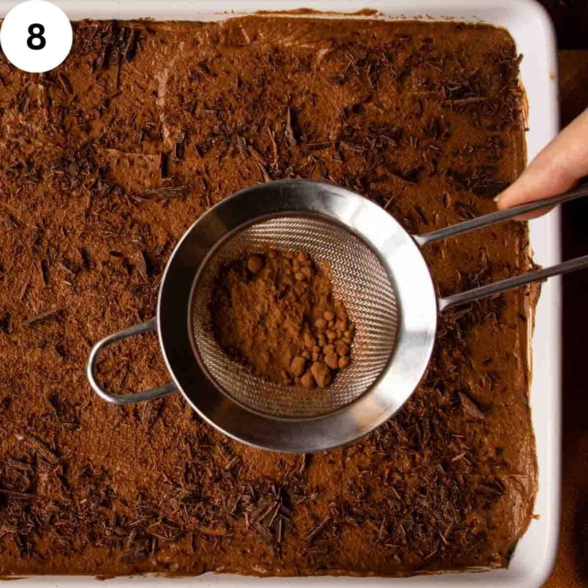 Cocoa being sprinkled onto a dessert.