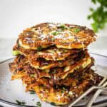 Italian zucchini fritters stacked on top of one another.
