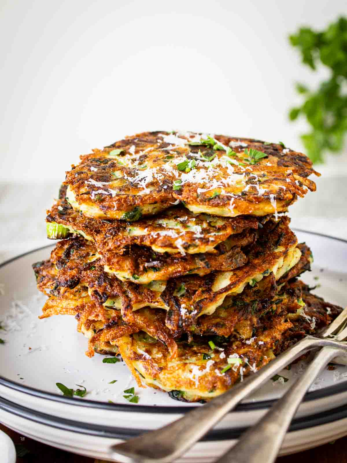 Italian zucchini fritters stacked on top of one another.