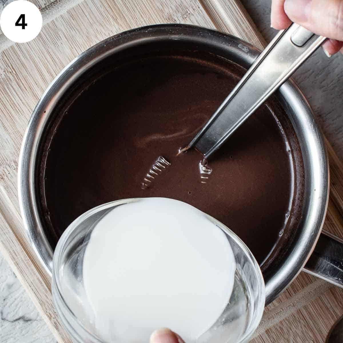Adding white liquid to chocolate mixture.