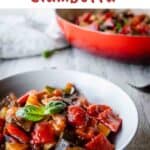 Ciambotta in a bowl with more in the background in a round pan.