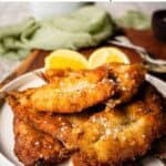 Fried sardines piled up on a round plate.