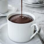 Italian Hot Chocolate being poured from a jug into a cup.