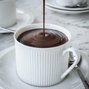 Italian Hot Chocolate being poured from a jug into a cup.