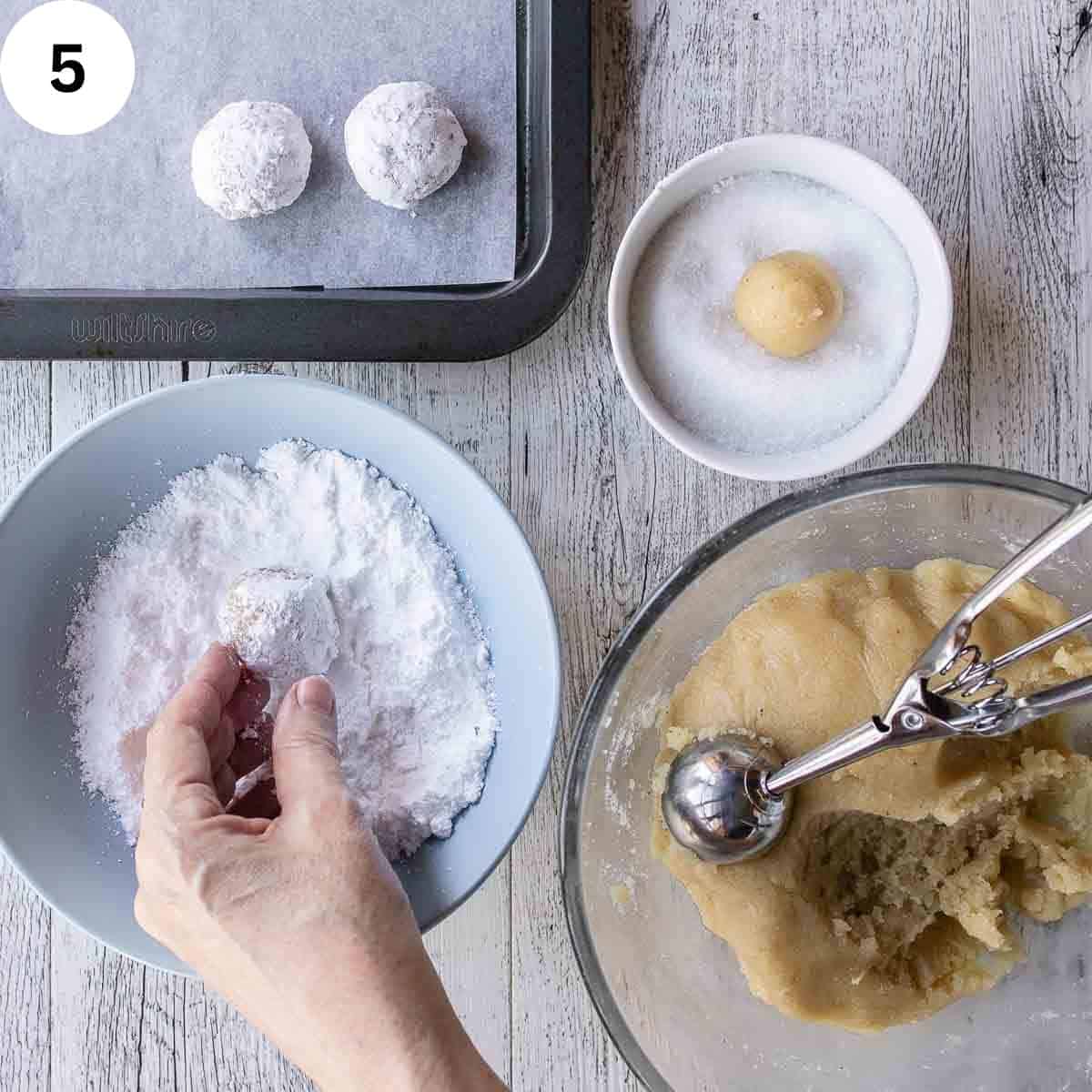 Dough rolled into balls and coated in powdered sugar.