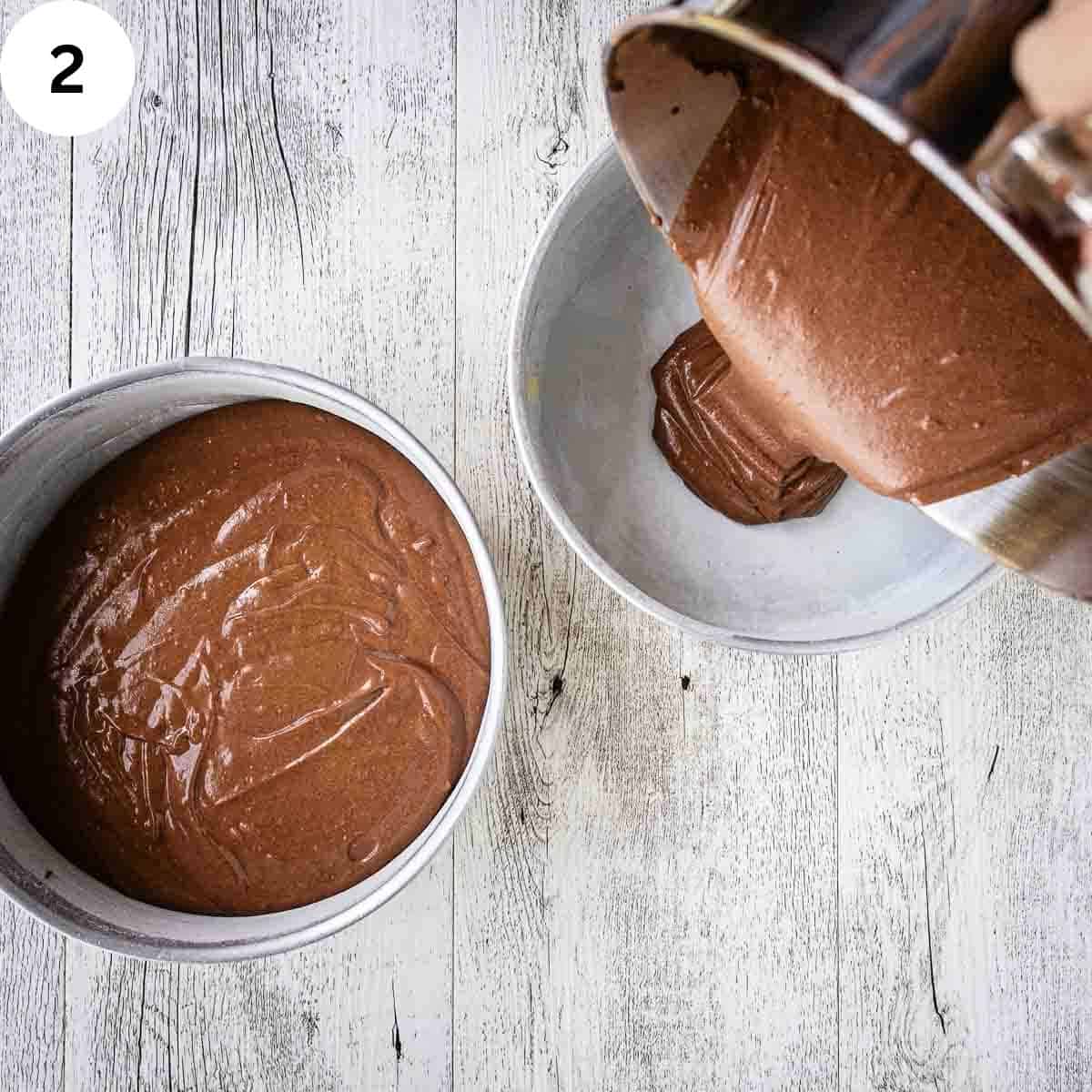 Chocolate cake batter being poured into round cake pans.