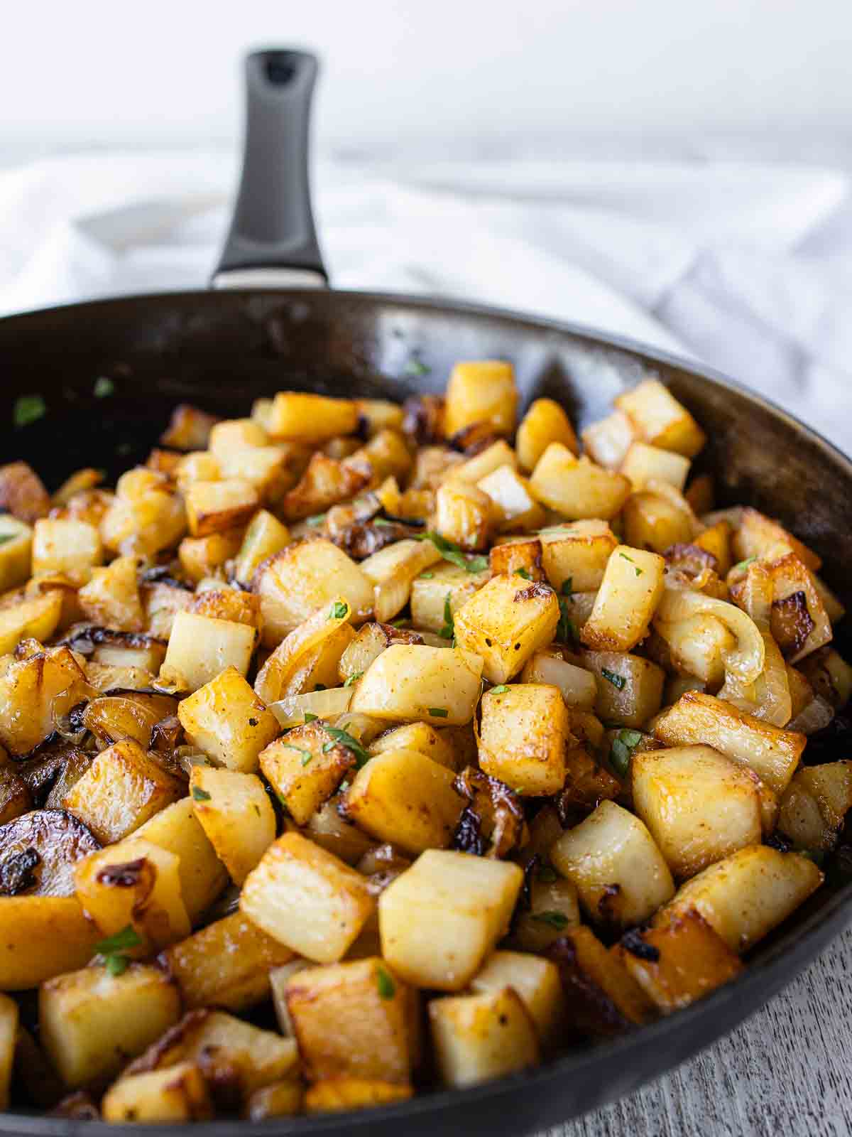Fried potatoes and onions in a skillet.