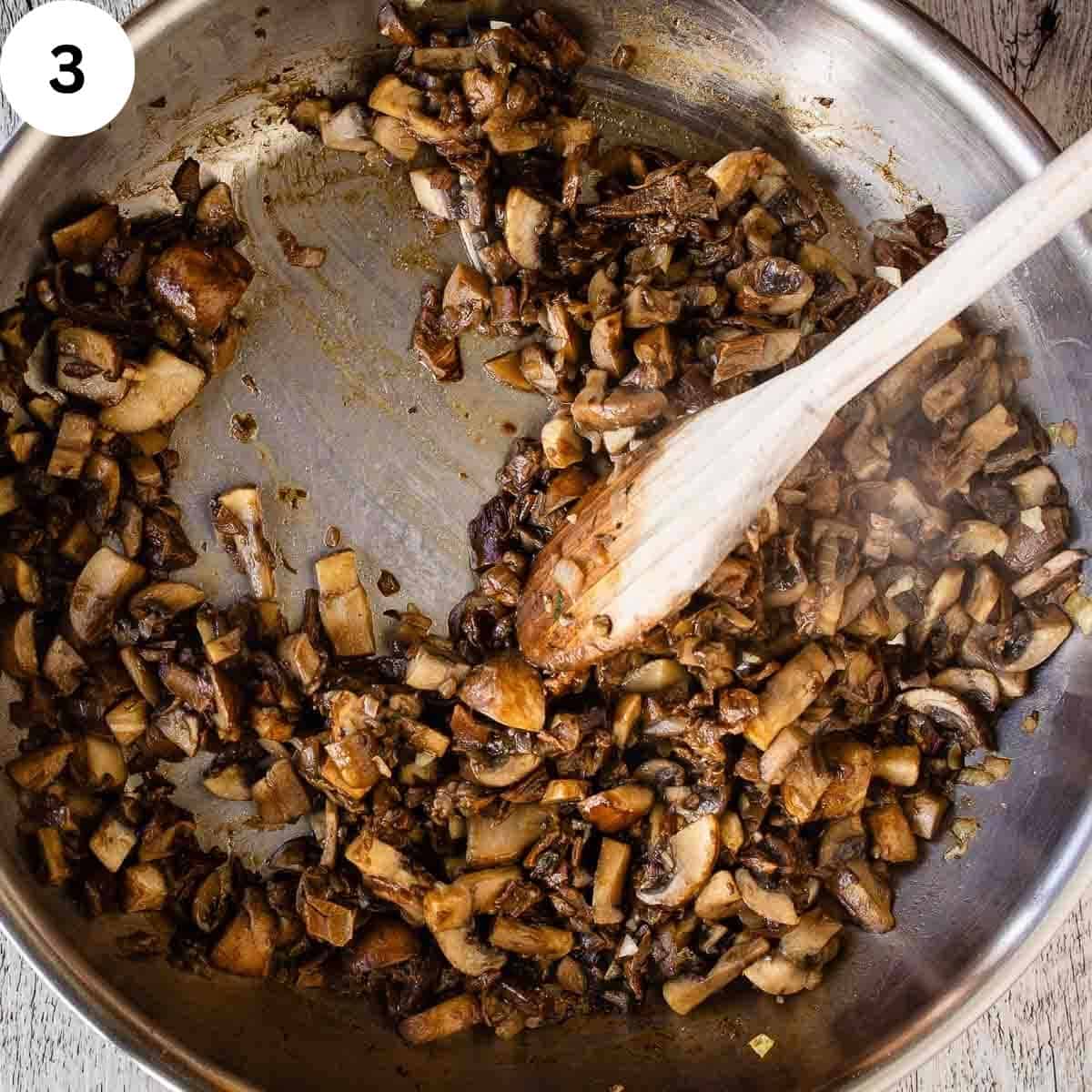 Cooked chopped mushrooms in a pan.