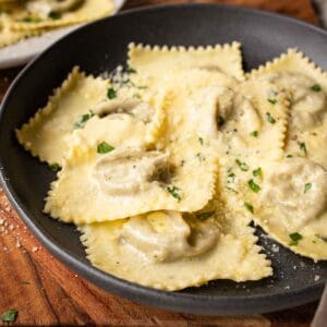 Mushroom Ravioli in a shallow bowl with a sprinkle of chopped parsley