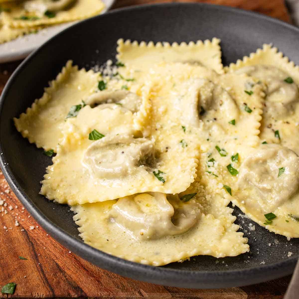 Mushroom Ravioli in a shallow bowl with a sprinkle of chopped parsley