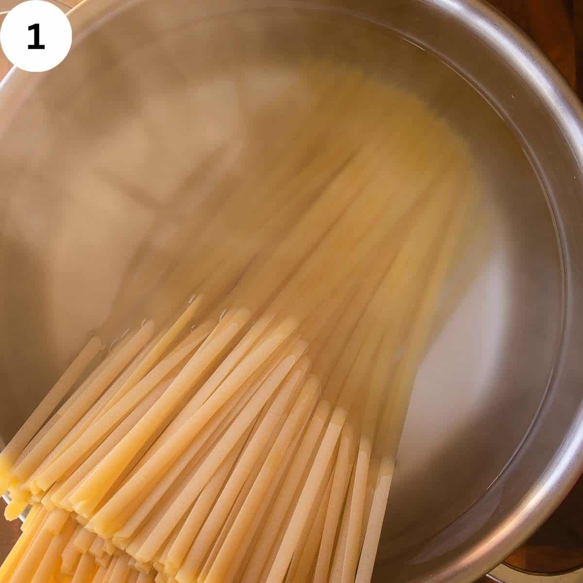 Dry fettuccini in a pot of water.