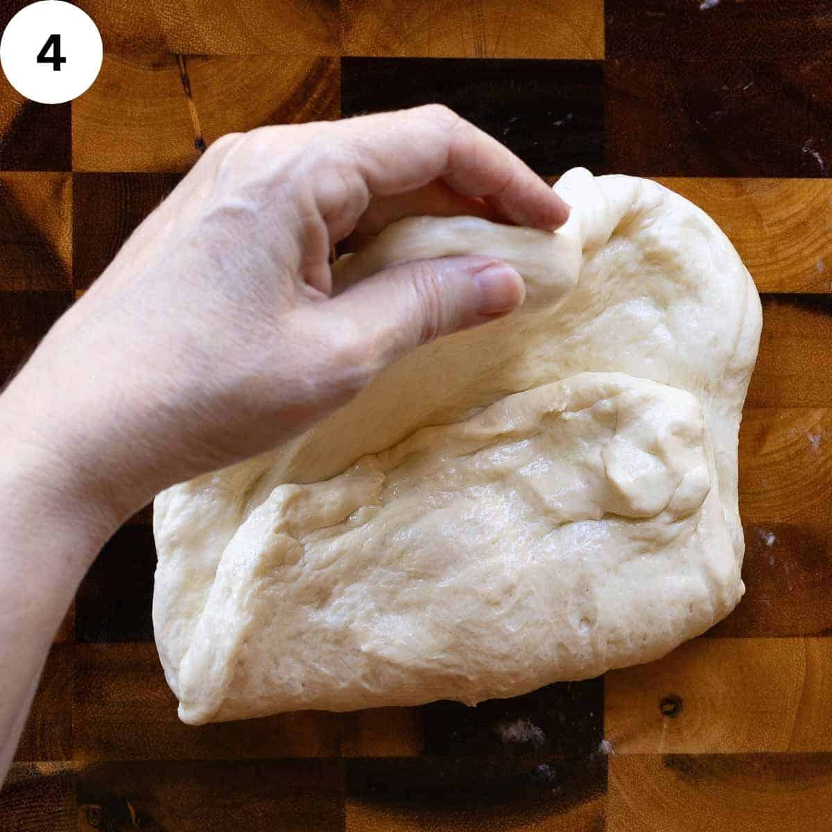 Folding bread dough.