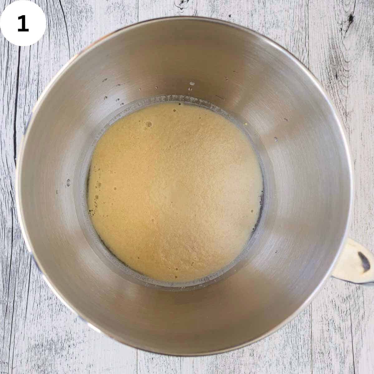Yeast proofing in a stainless steel bowl.