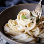 Cream cheese pasta in a bowl being twirled onto a fork.