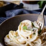 Cream cheese pasta in a bowl being twirled onto a fork.