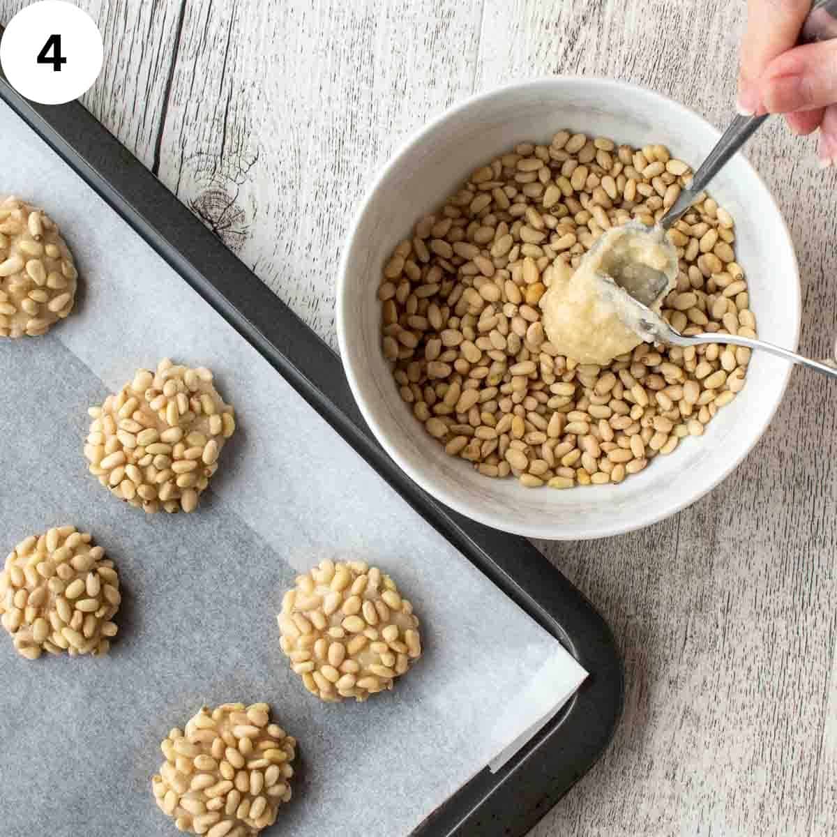 Soft batter being spooned into a bowl of pine nuts.