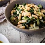 Beans and greens recipe prepared and served in a bowl.