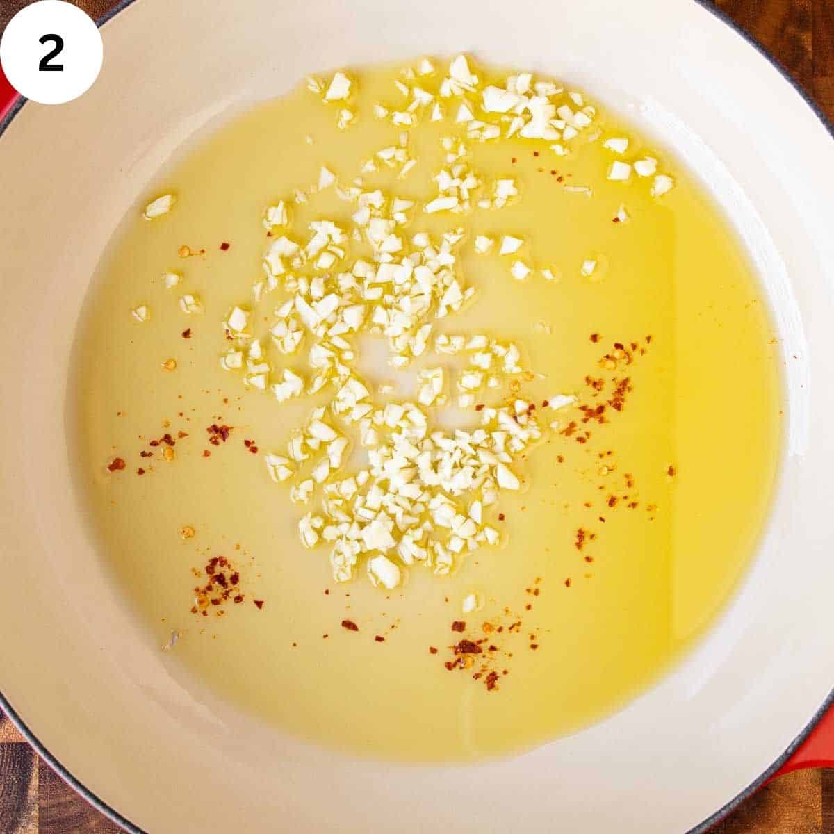 Chopped garlic, red pepper flakes and oil in a pan.