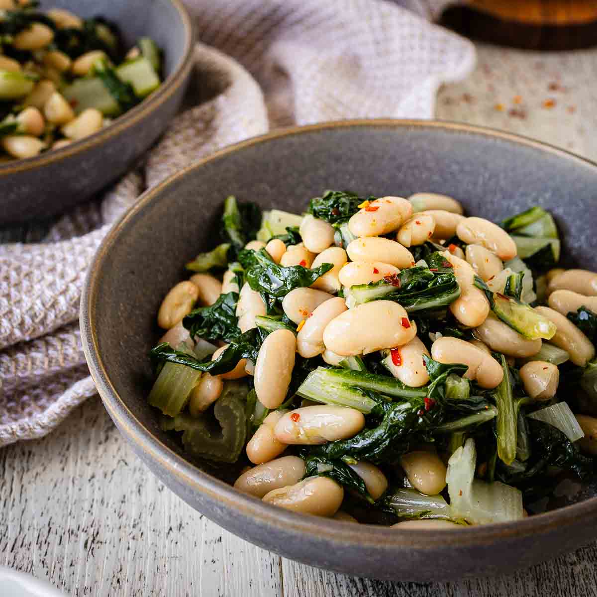 Beans and greens recipe prepared and served in a bowl.