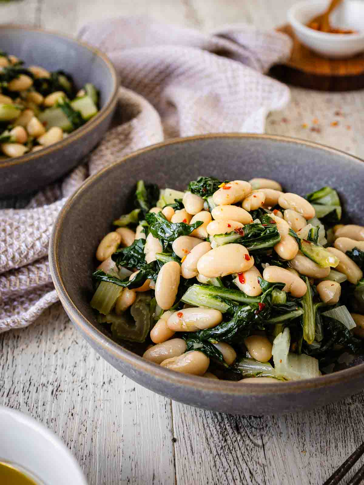 Beans and greens recipe prepared and served in a bowl.