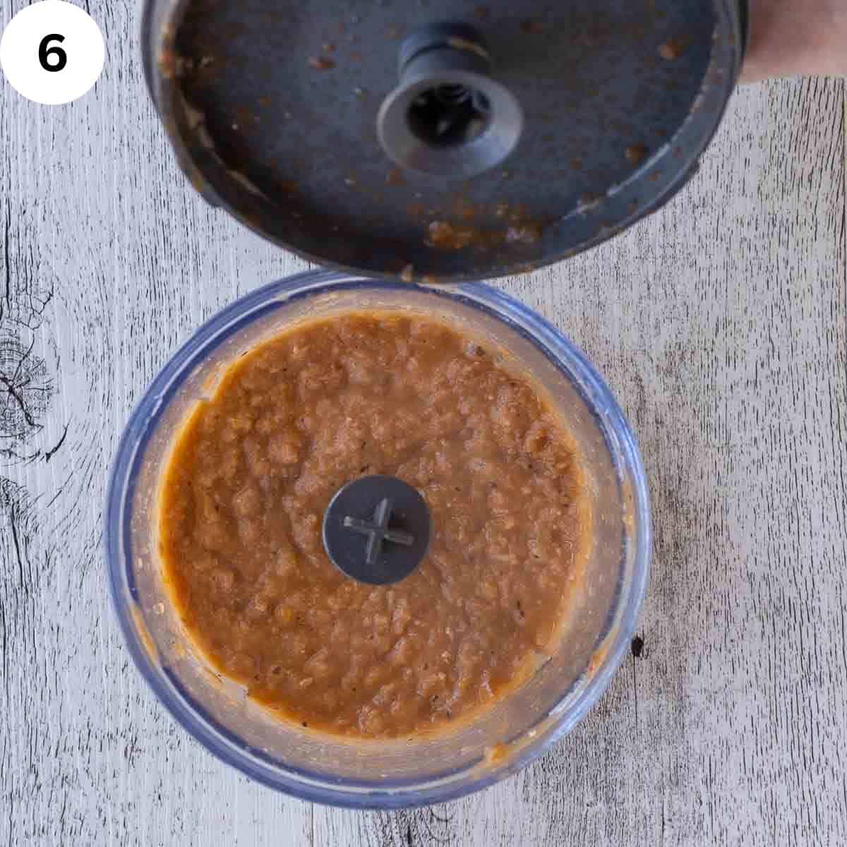 Blended brown creamy mixture in a mini blender.
