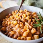 Authentic Italian Pasta e Fagioli Recipe prepared and in a bowl with a spoon.