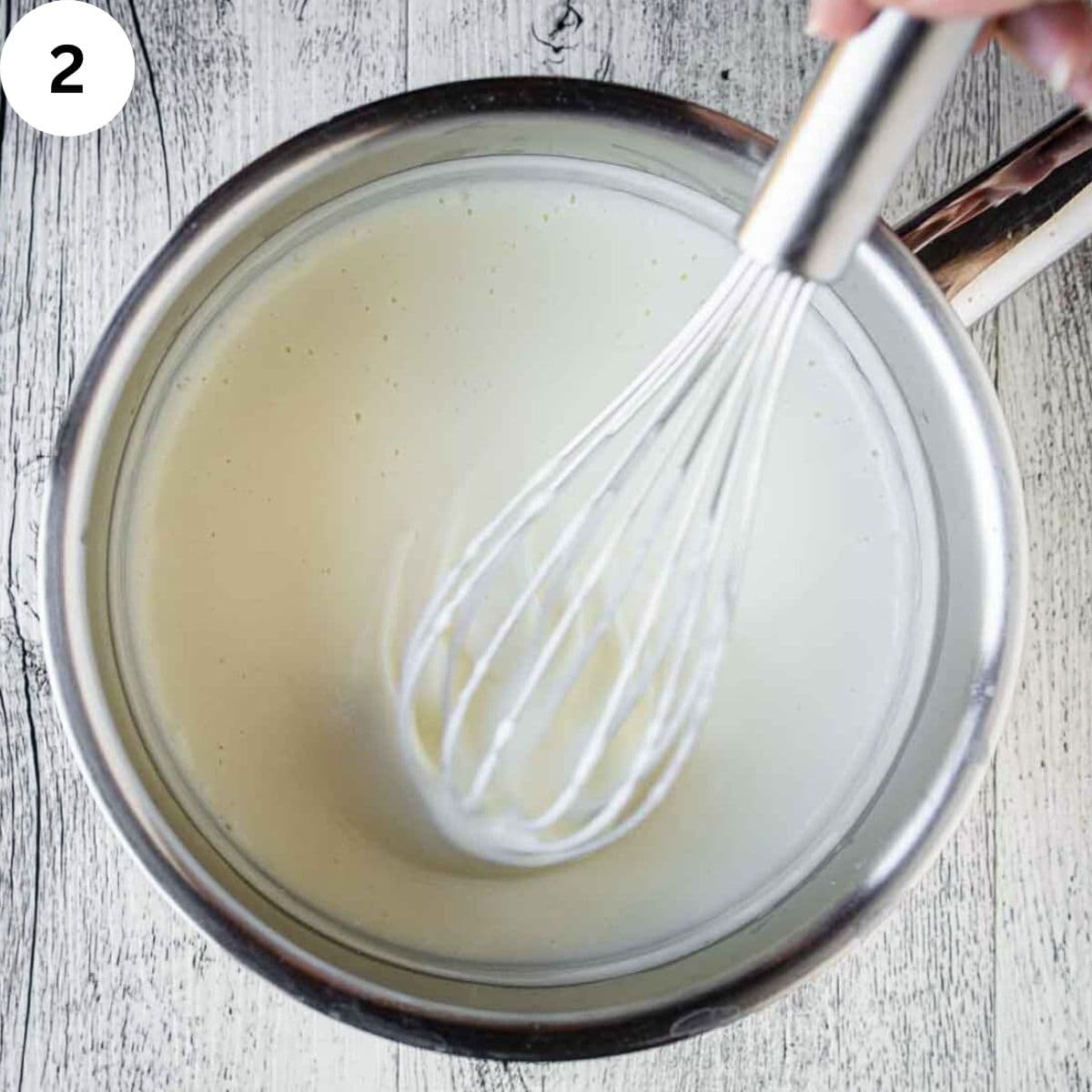 Whisking a creamy, white sauce.
