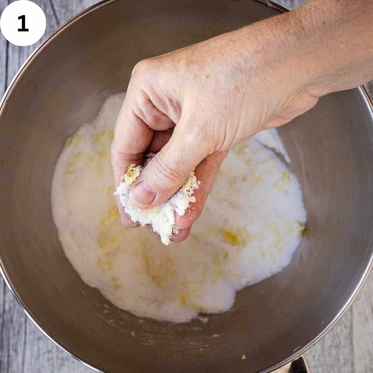 Rubbing lemon zest into white sugar.