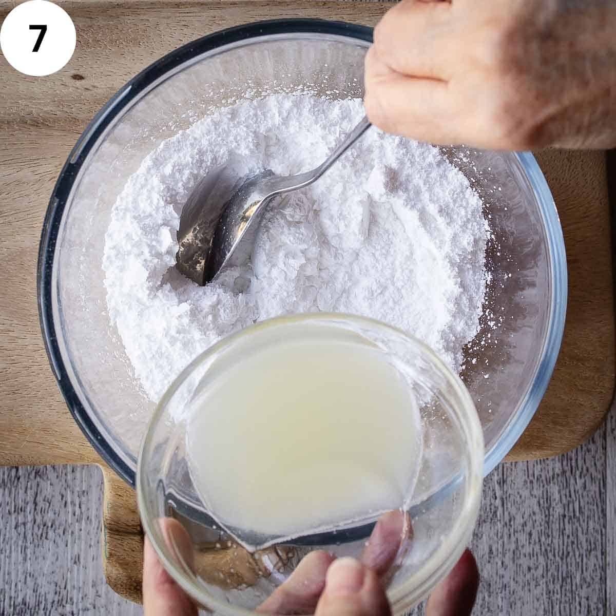 Adding lemon juice to powdered sugar.