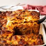 Baked Lasagna al Forno with a piece cut and being lifted out.