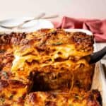 Baked Lasagna al Forno with a piece cut and being lifted out.