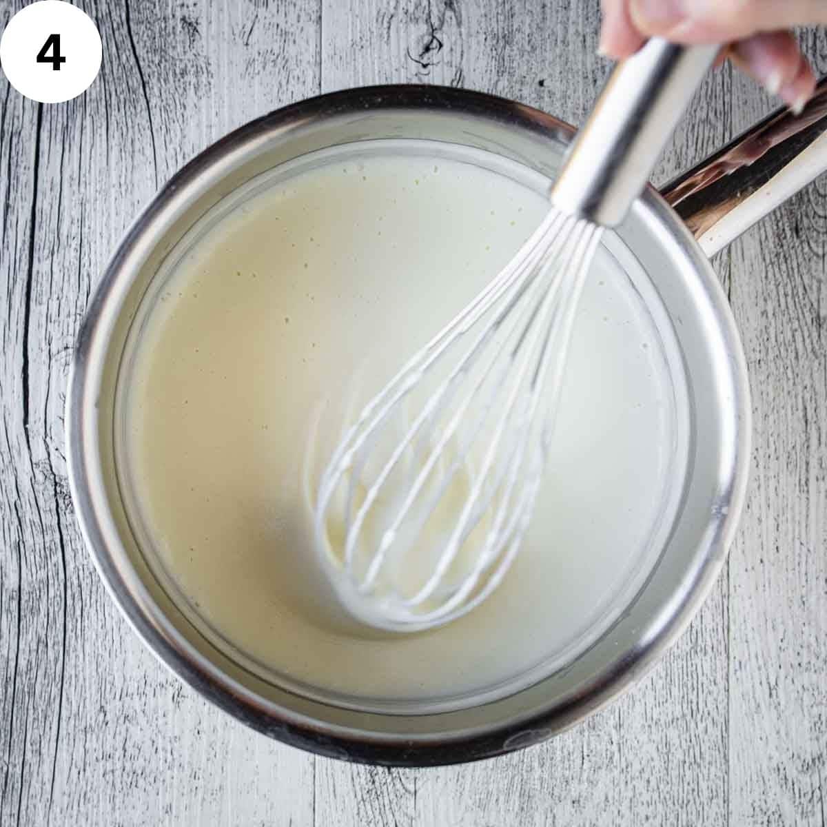 Whisking thick white sauce.
