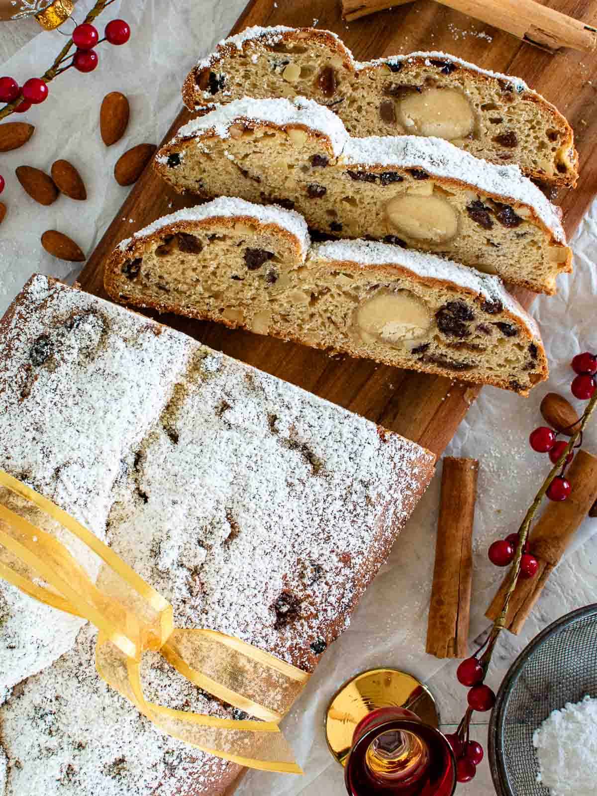 Stollen Bread viewed from above with three slices cut.