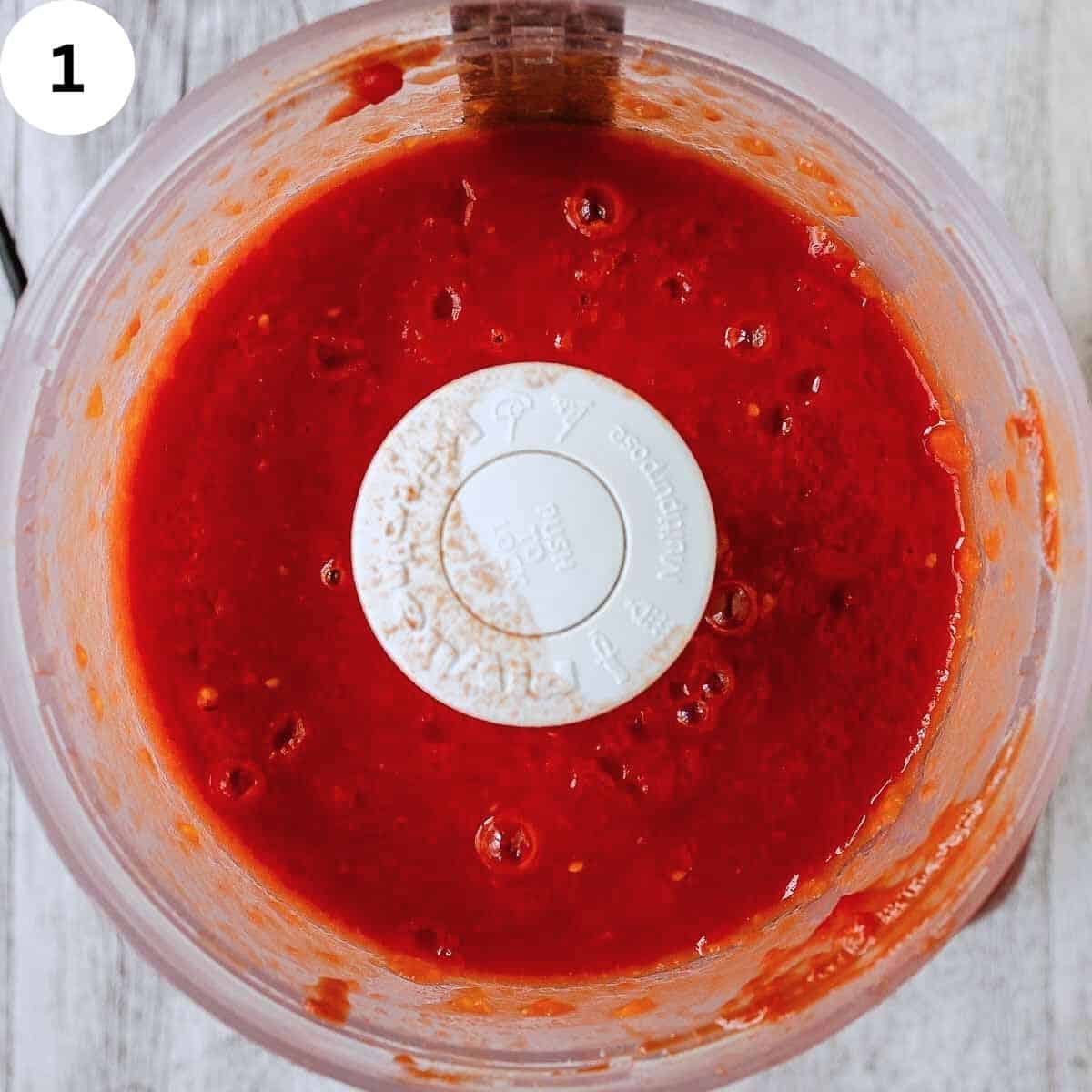 Pureed tomatoes in a food processor.