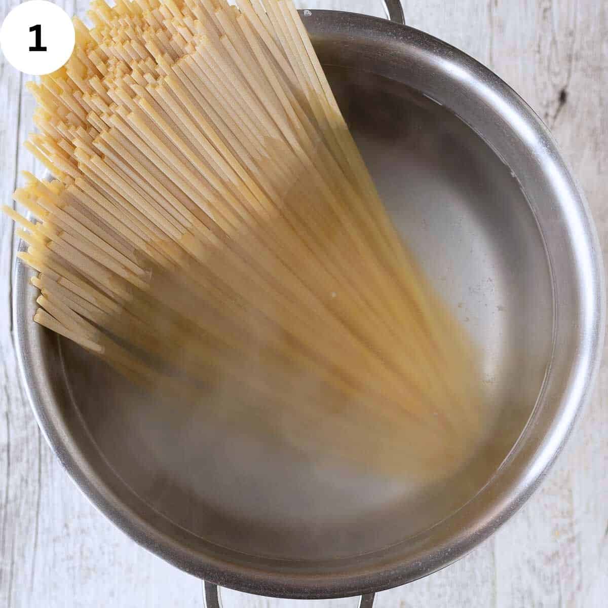 Linguine pasta in a pot of water.