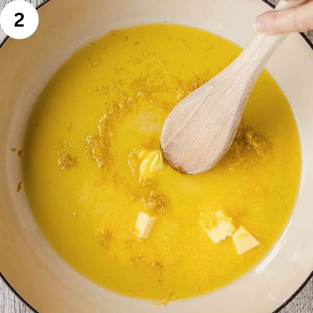 Stirring butter, olive oil and grated lemon zest in a pan.