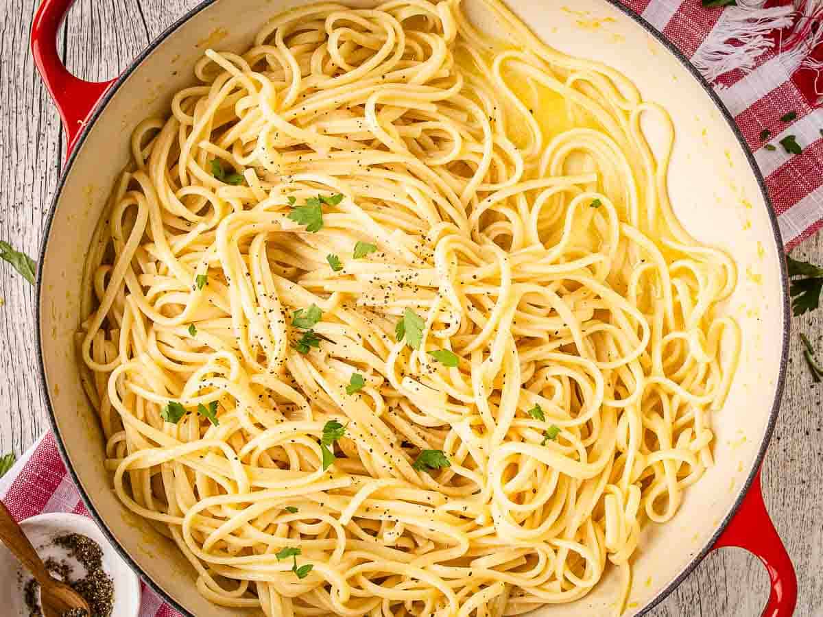 Cooked linguine pasta in a skillet viewed overhead.