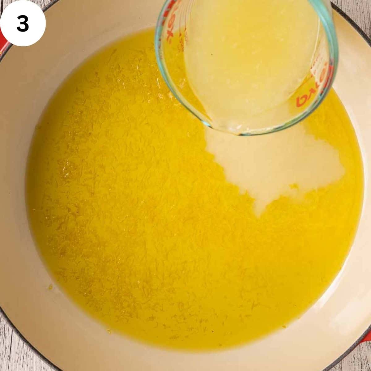 Adding lemon juice to melted butter and oil in a pan.