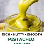 A pistachio cream recipe prepared and being spooned into a glass jar.
