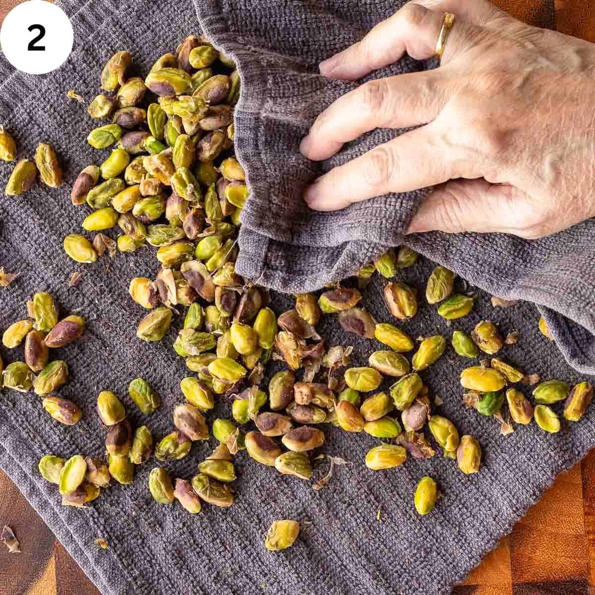 Rubbing pistachio nuts in a towel.
