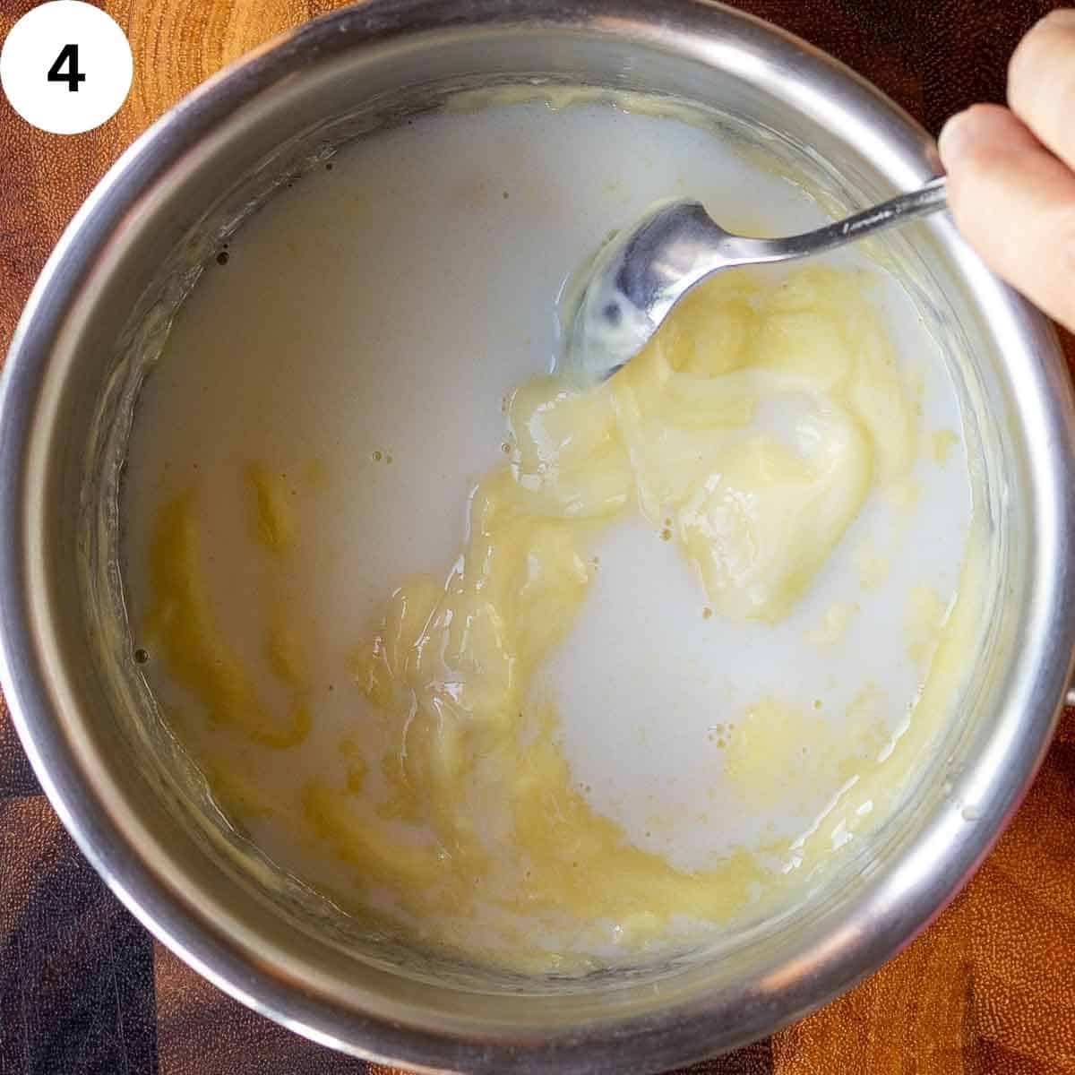 White chocolate and milk being melted in a saucepan.