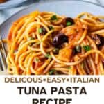Plate of tuna pasta consisting of spaghetti in tomato sauce, with olives and chopped parsley.