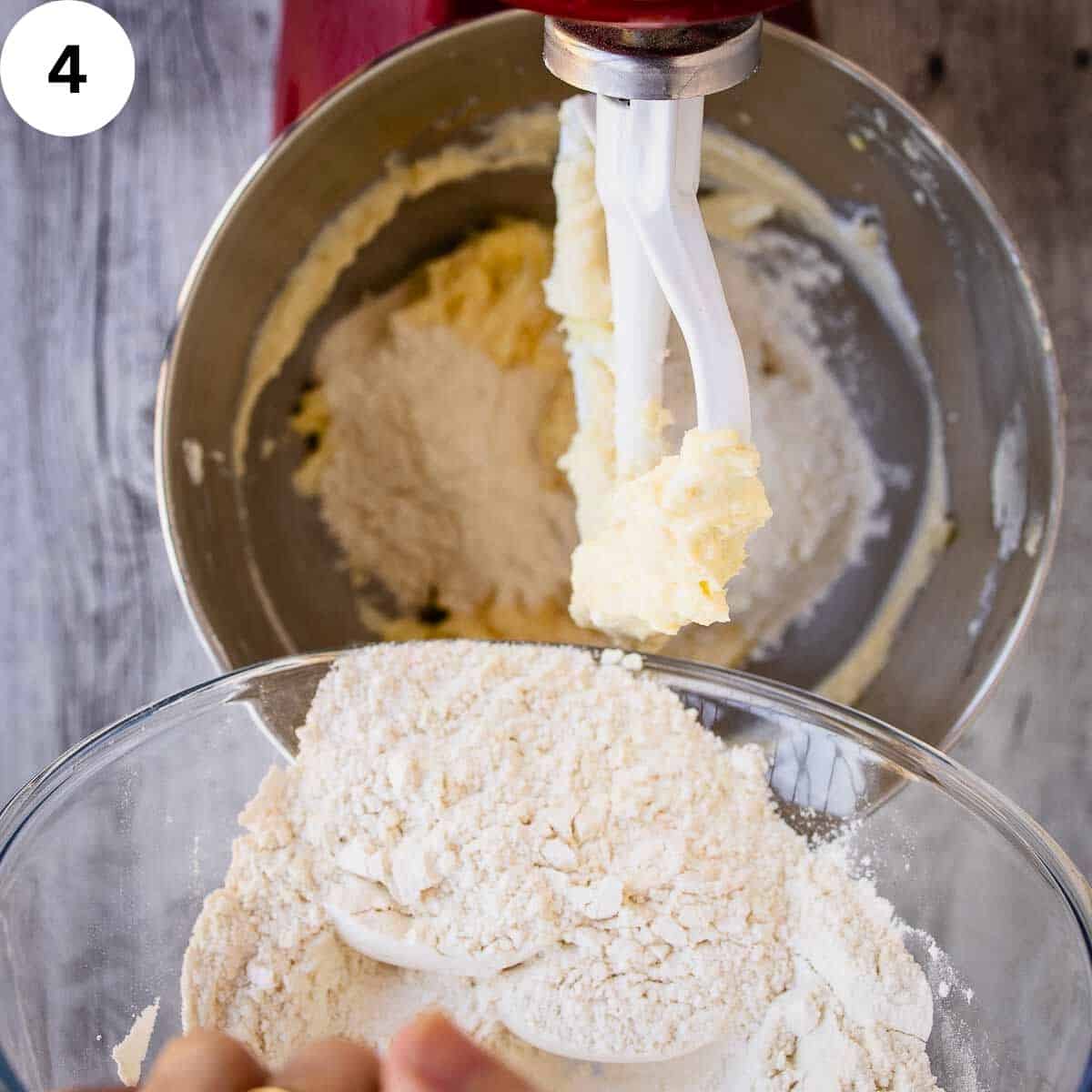 A hand adding flour into a bowl.